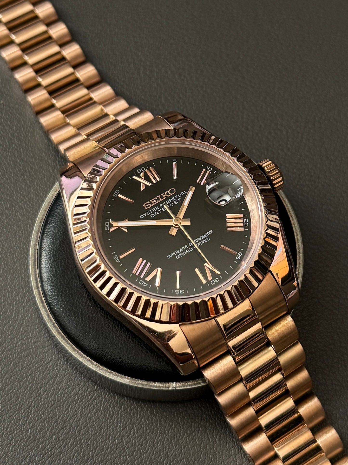 DateJust: Rose Gold Black Dial Roman Numeral Markers w/ Presidential Bracelet