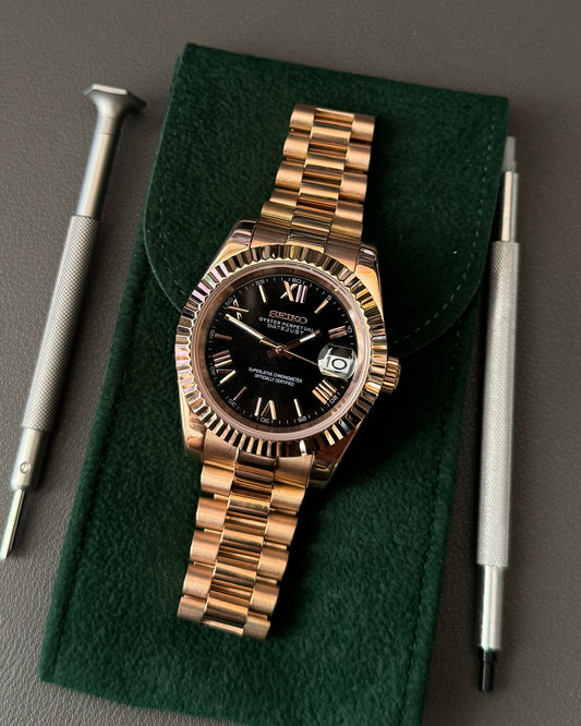 DateJust: Rose Gold Black Dial Roman Numeral Markers w/ Presidential Bracelet