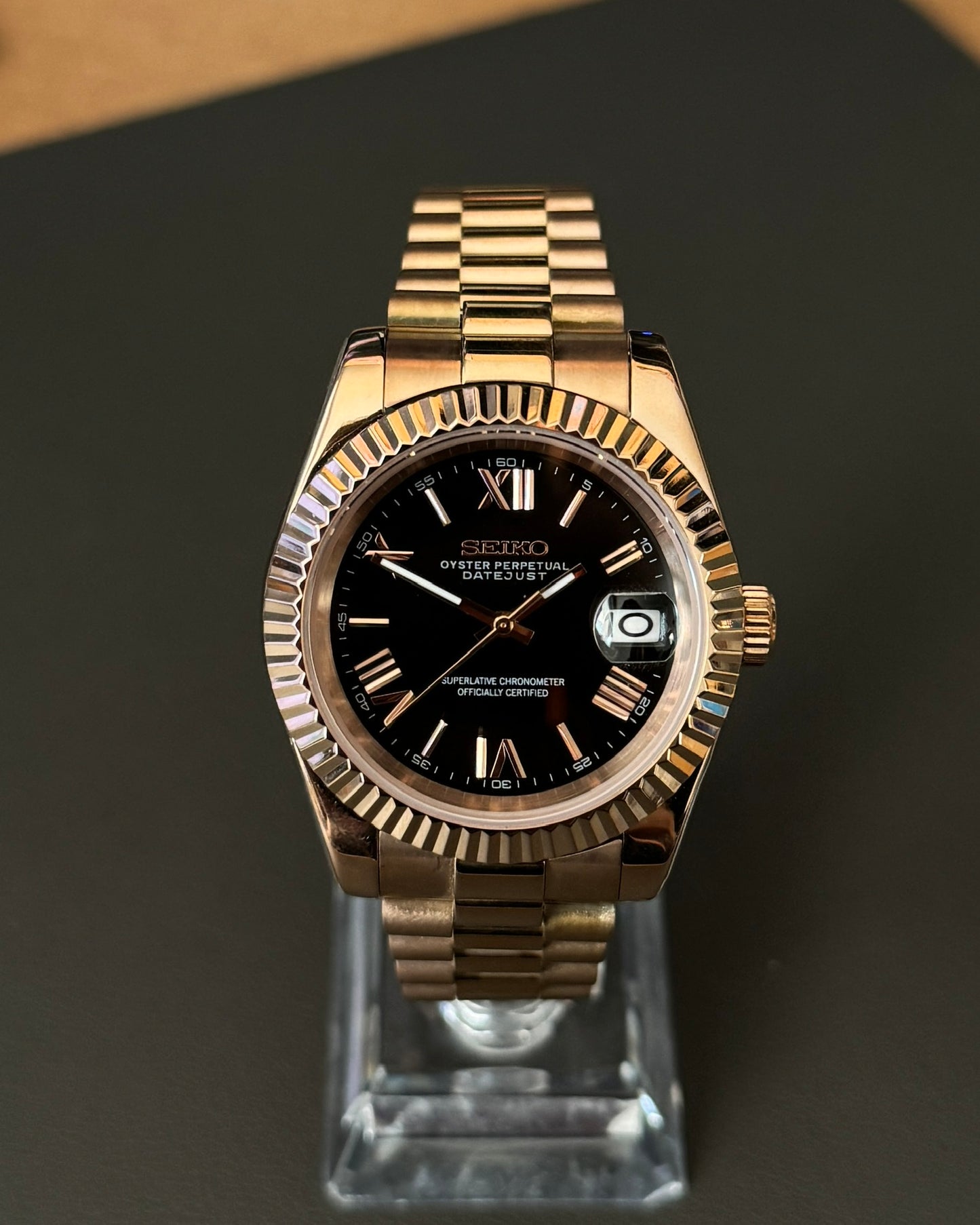 DateJust: Rose Gold Black Dial Roman Numeral Markers w/ Presidential Bracelet