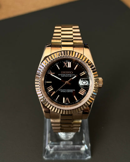 DateJust: Rose Gold Black Dial Roman Numeral Markers w/ Presidential Bracelet